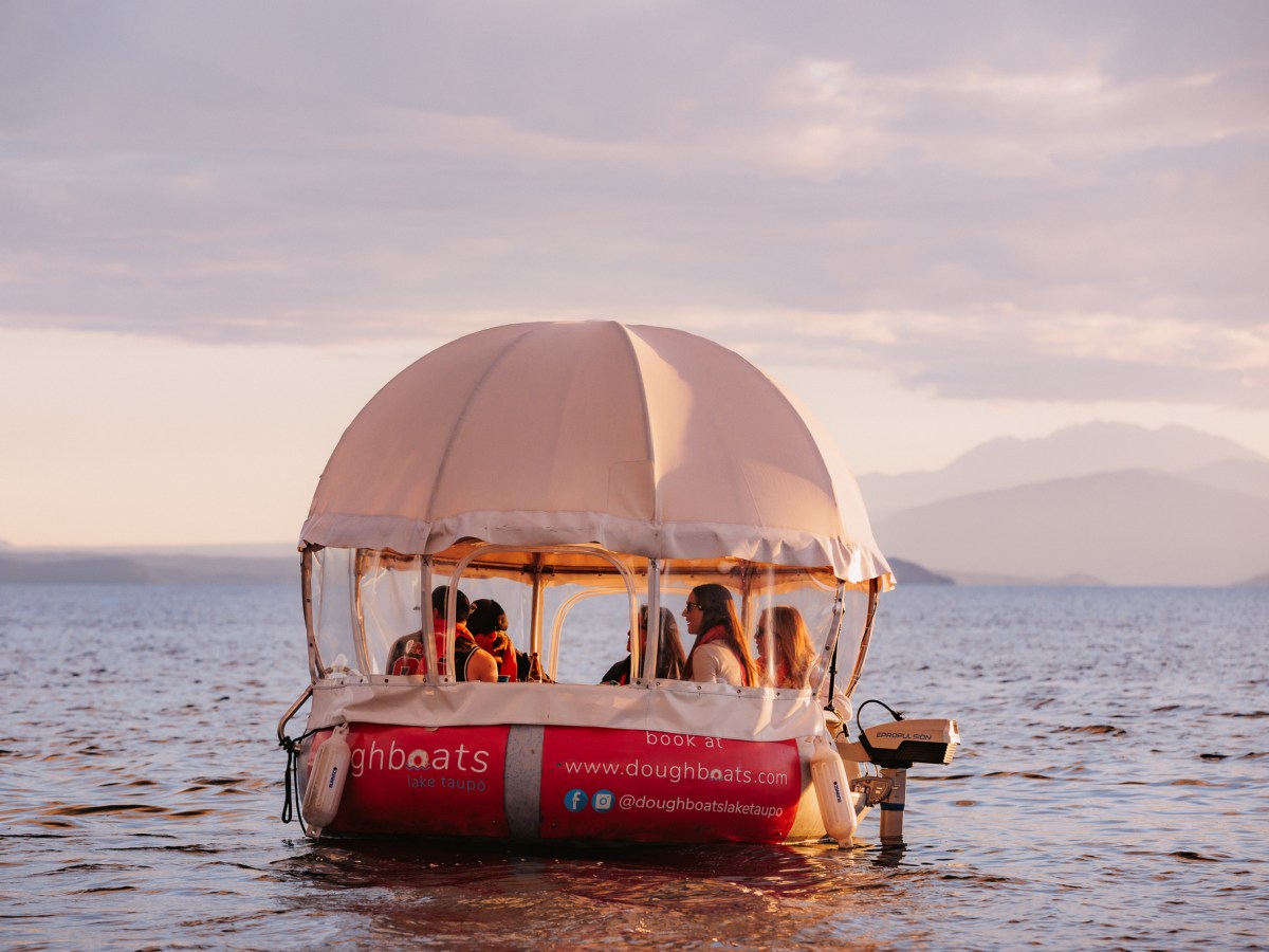 a close up of an umbrella on a beach near a body of water